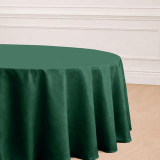 Green round tablecloth on a wooden floor.