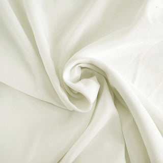 Soft, flowing white fabric in a gentle swirl pattern.