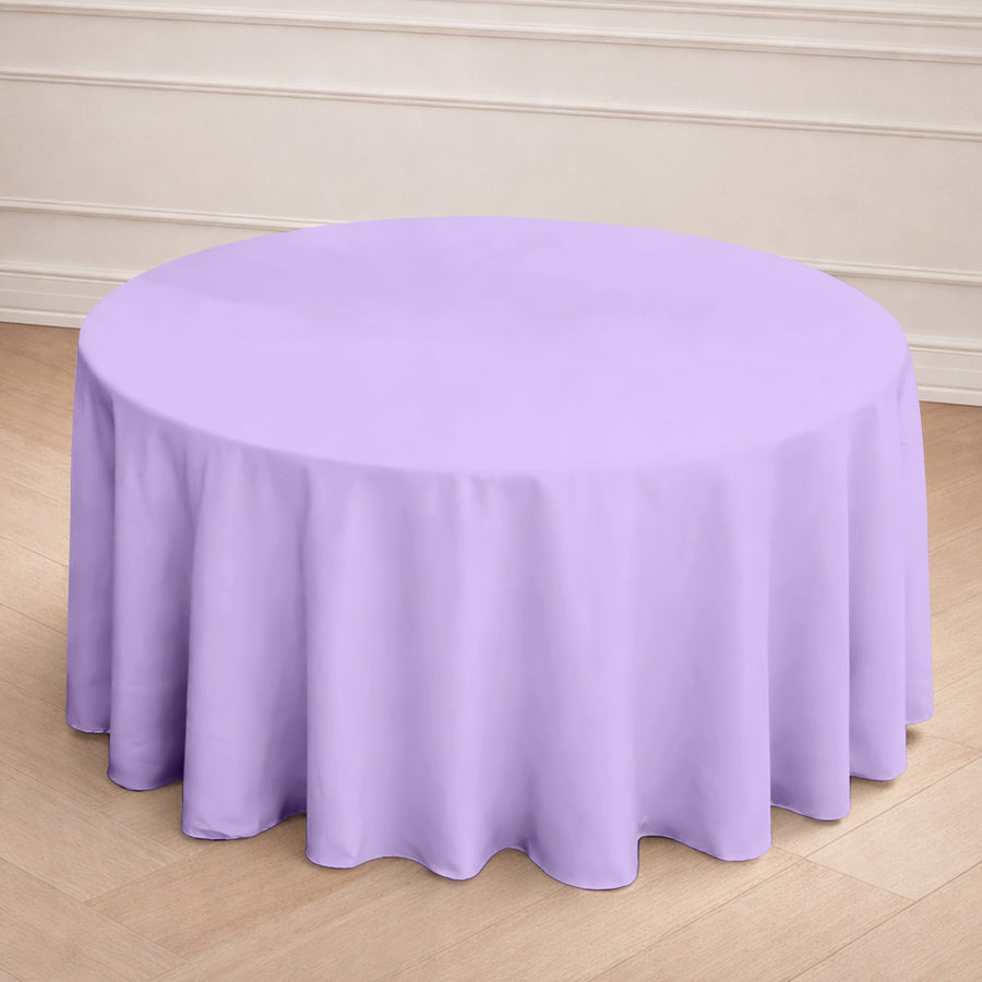 Round purple tablecloth draped over a table in a light indoor setting.