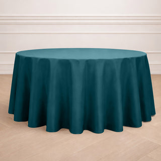 Teal round tablecloth on a wooden floor.