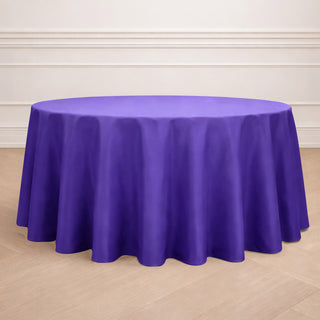 Purple round tablecloth on wooden floor.