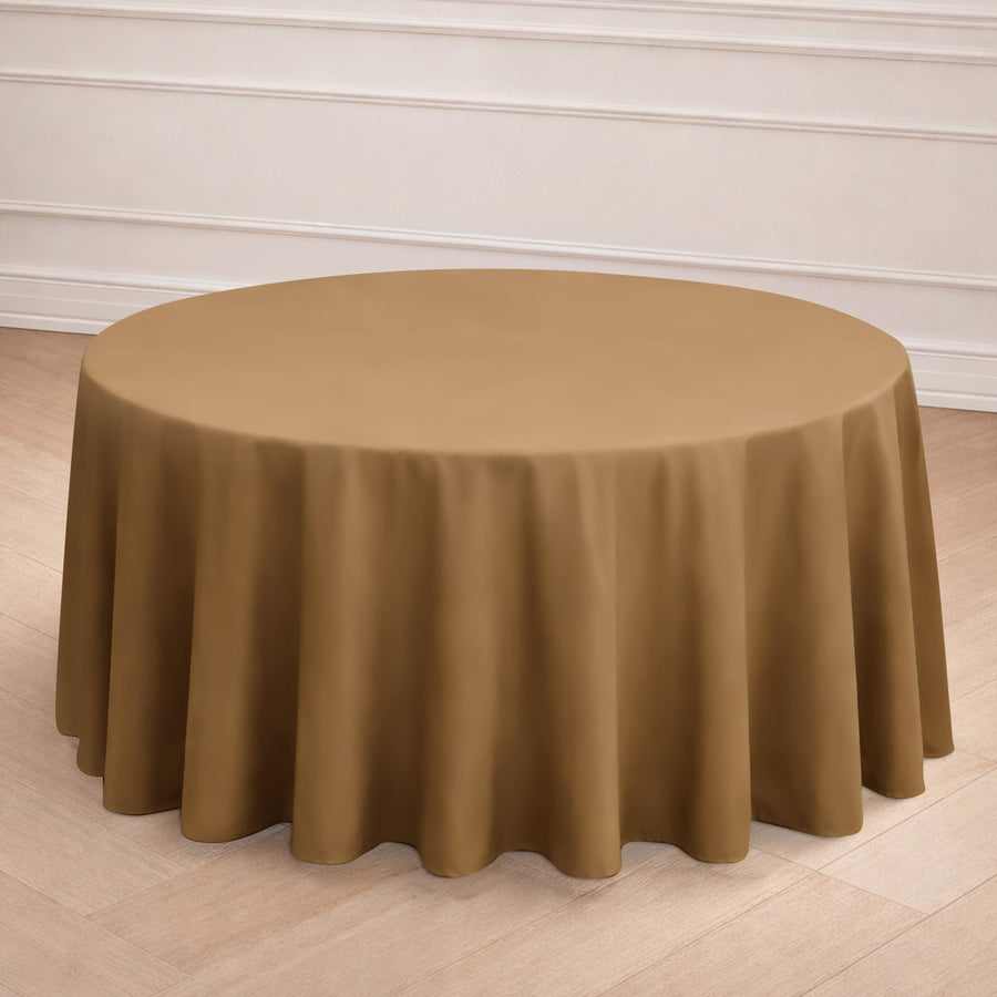 Round brown tablecloth draped over a round table in a minimalist setting.