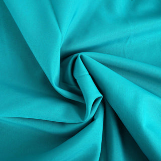 Teal fabric with a smooth texture and gentle folds.
