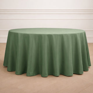 Round green tablecloth on a wooden floor.