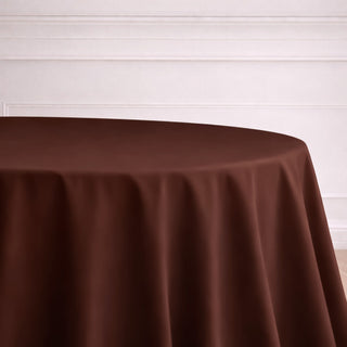 Brown tablecloth on a round table in a minimalist setting.