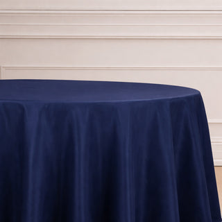 Navy blue round tablecloth on a plain backdrop