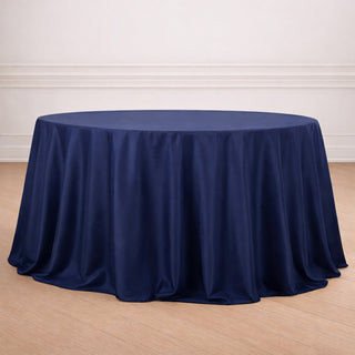 Navy blue round tablecloth draped elegantly on a wooden floor.