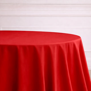 Red tablecloth draped elegantly over a round table.