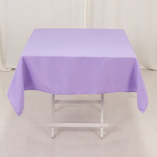 Purple tablecloth draped over a table in a studio setting.