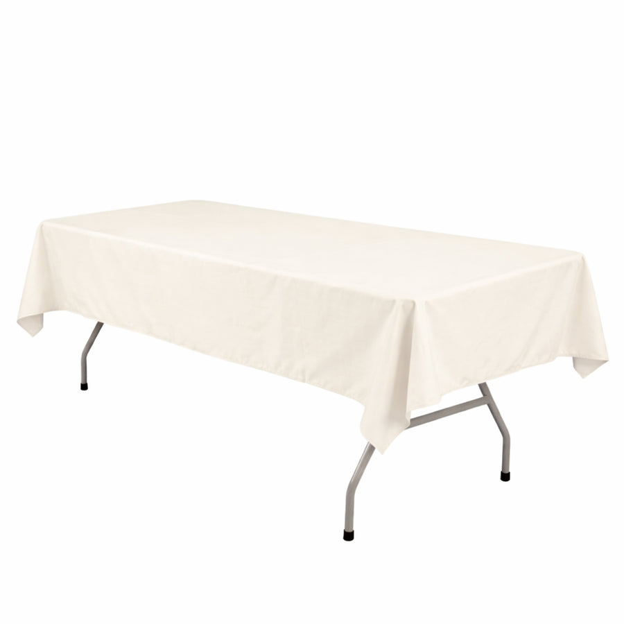 White rectangular folding table with ivory tablecloth on a white background
