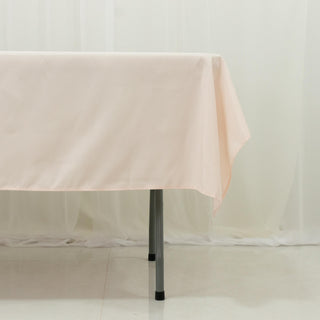 Peach tablecloth draped over a table in a studio setting.