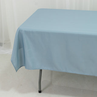 Blue tablecloth draped over a table in a bright setting.