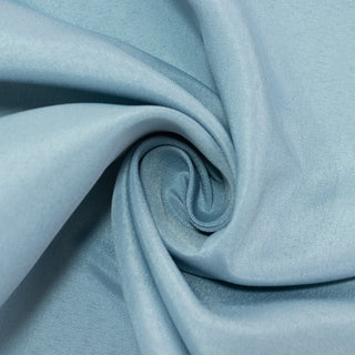 Light blue fabric with a smooth texture, folded in a spiral pattern. #whtbkgd