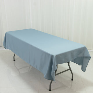 Blue tablecloth draped over a folding table in a studio setting.