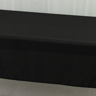 Black tablecloth draped over a table, showcasing smooth fabric texture.