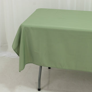 Green tablecloth draped over a table in a studio setting.