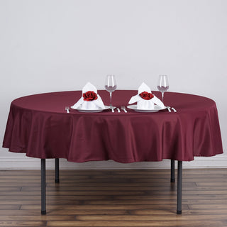 Elevate Your Event with the 70" Round Burgundy Polyester Linen Tablecloth Elevate Your Event with the 70" Round Burgundy Polyester Linen Tablecloth