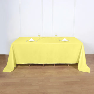 Brighten Up Your Event with a Yellow 90"x132" Seamless Polyester Rectangular Tablecloth