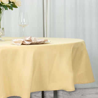Experience Elegance and Durability with the 90" Champagne Premium Polyester Round Tablecloth Experience Elegance and Durability with the 90" Champagne Premium Polyester Round Tablecloth