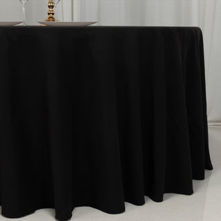 Black tablecloth draping elegantly over a round table.