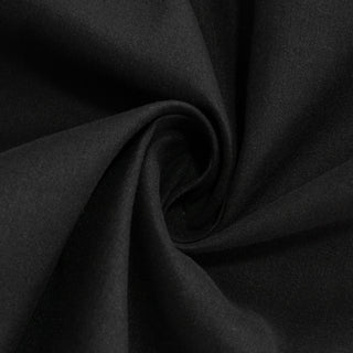 Black fabric texture in a swirling pattern.