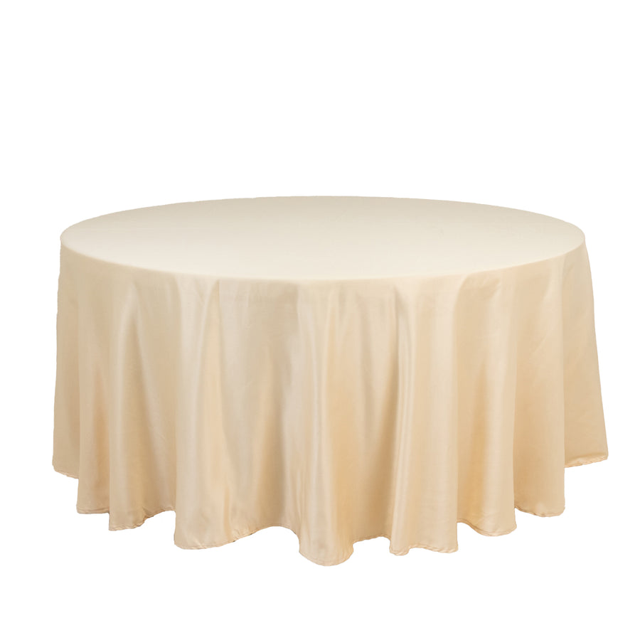 Round table with a beige tablecloth on a plain white background