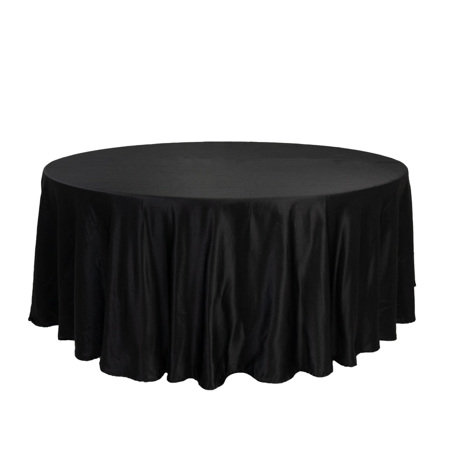 Black round tablecloth with elegant draping.