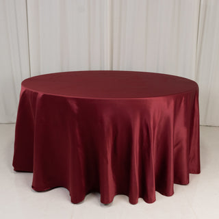 <strong>Seamless Burgundy Lamour Satin Round Tablecloth 120”</strong> <strong>Seamless Burgundy Lamour Satin Round Tablecloth 120”</strong>