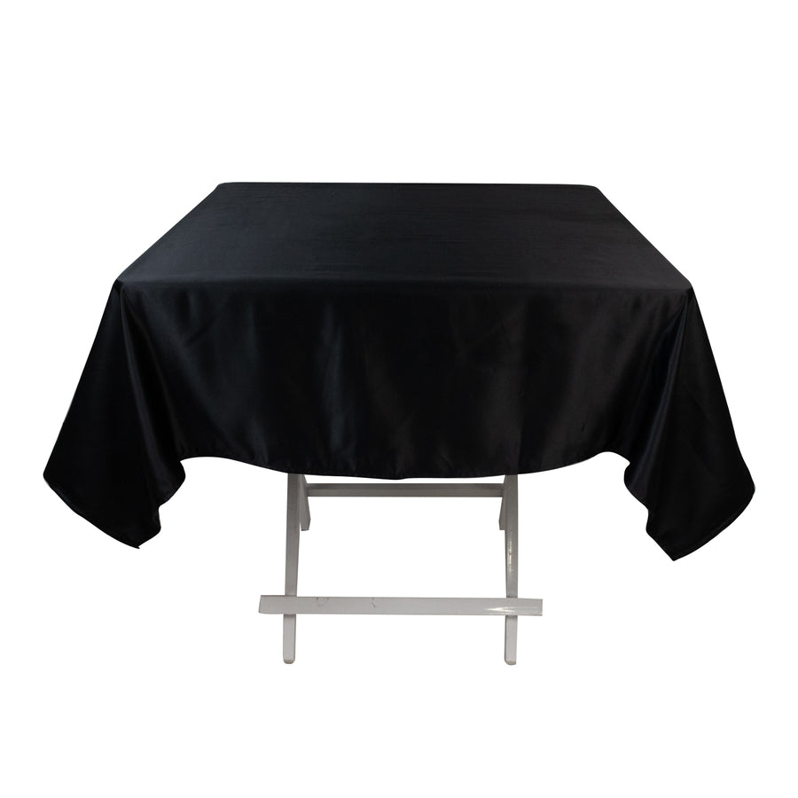 Black satin tablecloth on a white table.