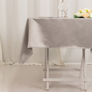 Elegant gray satin tablecloth draped over a folding table.