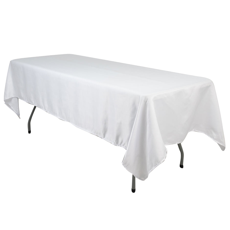 White tablecloth draped over a folding table in a studio setting
