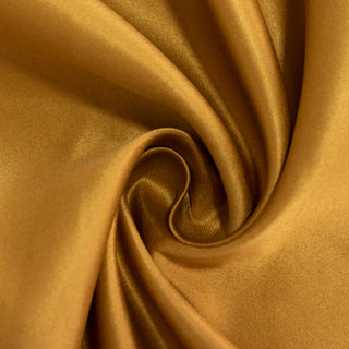Gold satin fabric close-up showcasing smooth texture and sheen.