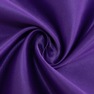 Purple satin fabric in a swirling pattern.