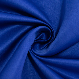 Blue satin fabric swirl texture close-up.