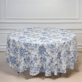 Round floral tablecloth in blue and white on a plain backdrop.