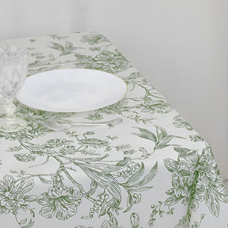 Floral print tablecloth with plate and glassware on a dining table.