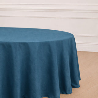 Round blue tablecloth draped over an elegant table in a styled setting.
