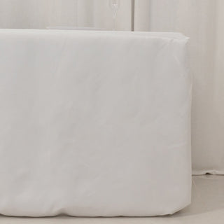 White table cover on a plain backdrop, ideal for events and parties.