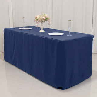 Navy tablecloth draped over a table with decorative centerpiece and plates.