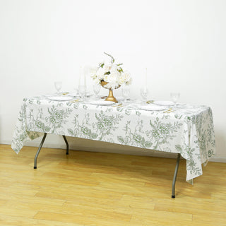 Floral tablecloth set on a dining table with elegant decor and tableware.