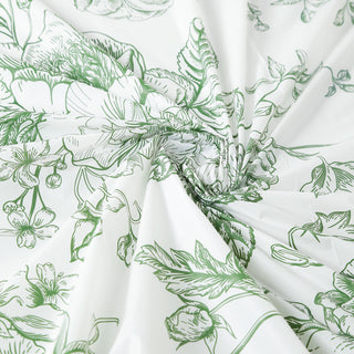 Floral patterned fabric with green illustrations on a white background.