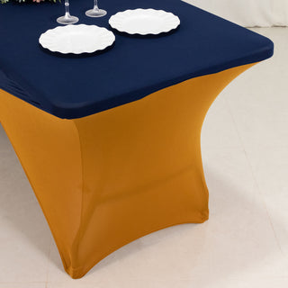 Navy and gold table cover draped over a table with white plates