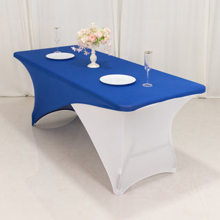 Blue and white table cover with plates and glasses on a dining table.