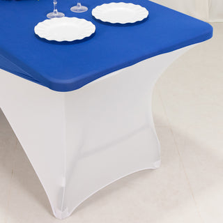 Blue table cover on a white table with plates