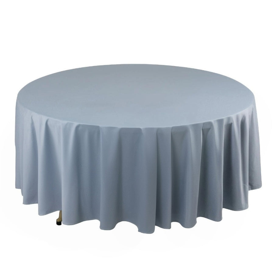 Round gray tablecloth with elegant draping on a white backdrop