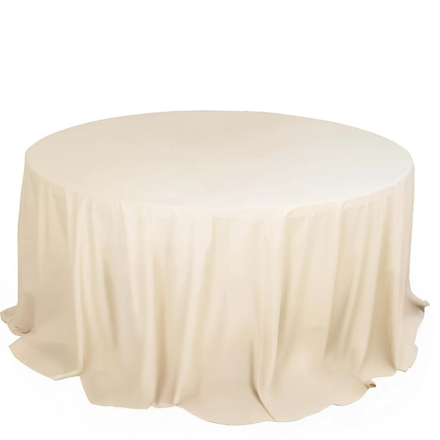 Round beige tablecloth with soft draping.