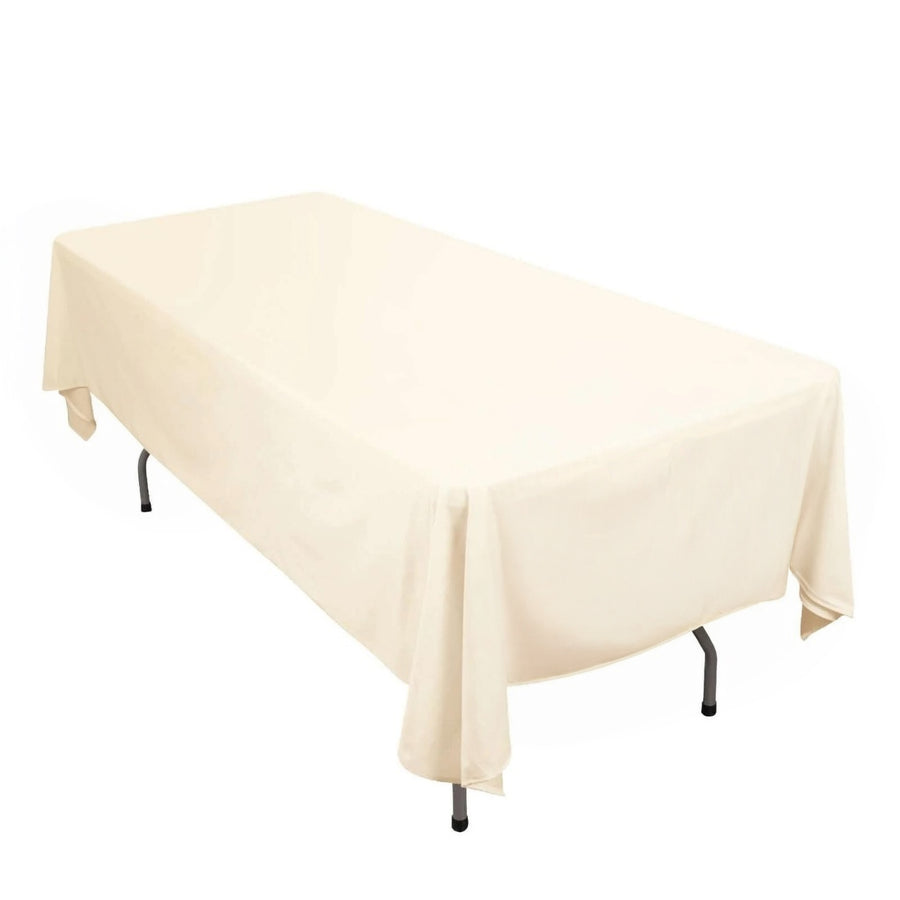Cream tablecloth draped over a folding table, studio shot.