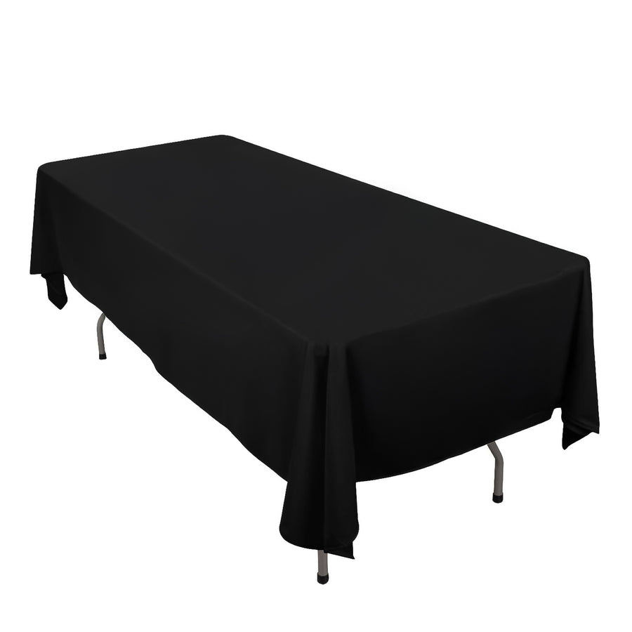 Black tablecloth draped over a rectangular table