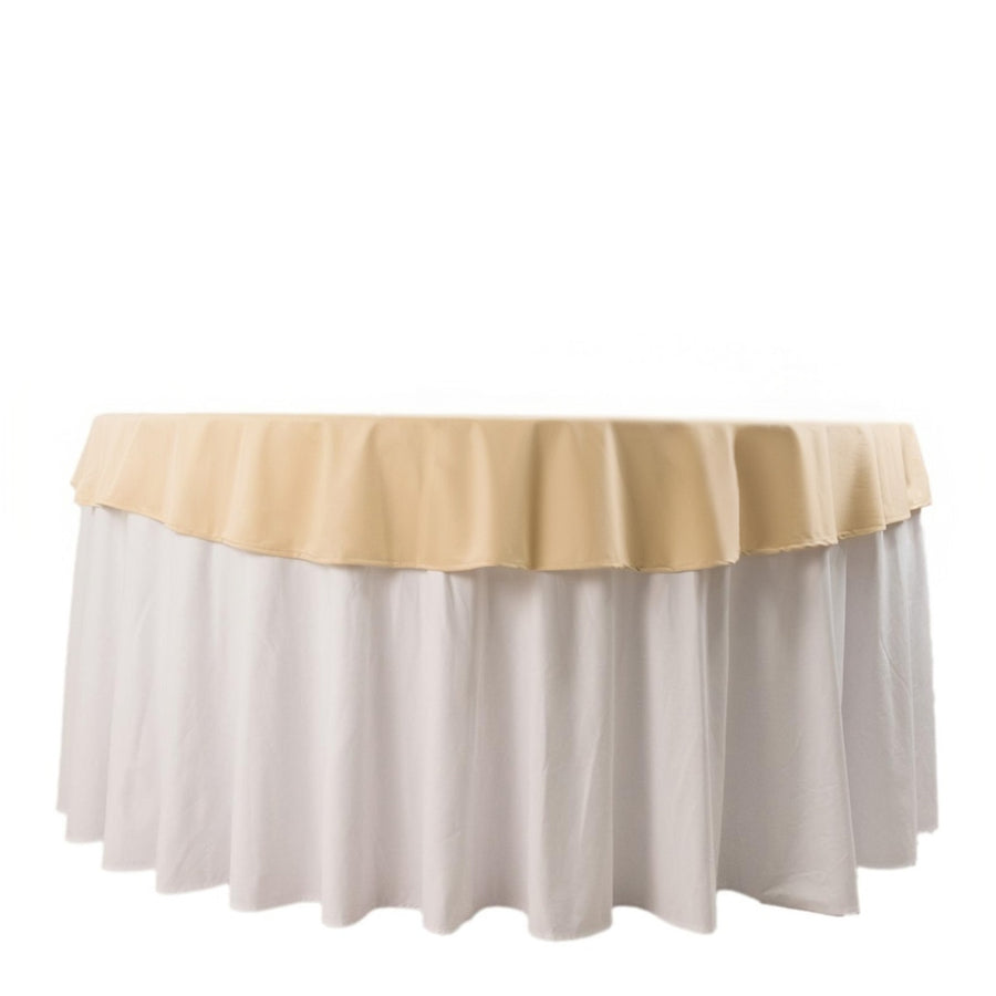 Beige tablecloth with white ruffled skirt in studio isolation shot.