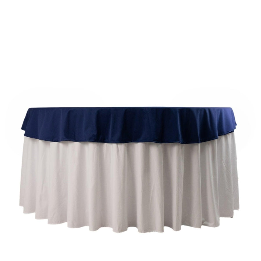 Navy and white tablecloth with ruffled edges on a round table